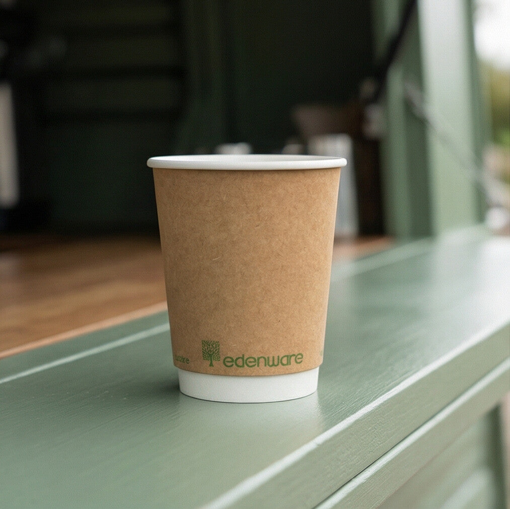 12oz compostable kraft double wall paper cup open on green painted shelf in coffee shop