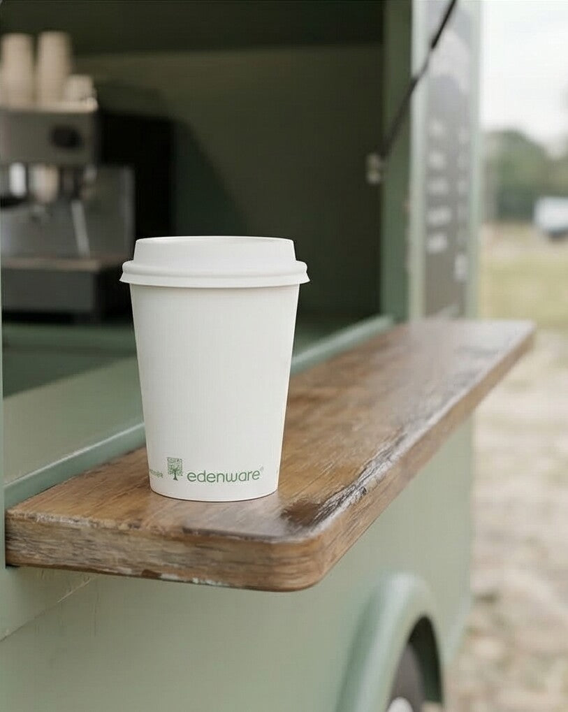 12oz compostable white single wall paper cup with lid on wooden shelf of an outdoor coffee van
