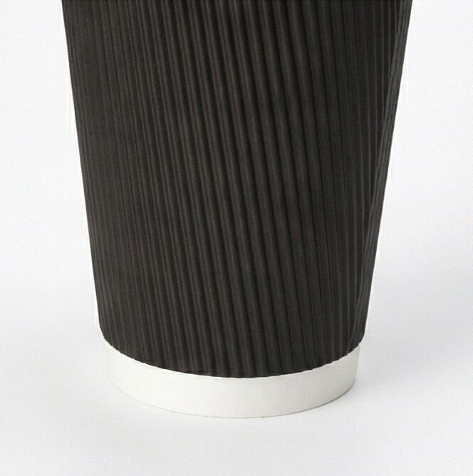Close-up of the lower black vertical ripple exterior and white base band of a 12oz ripple wall paper cup on white