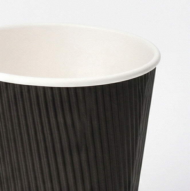Close-up of the white rim and black vertical ripple texture of a 12oz ripple wall paper cup, light grey background