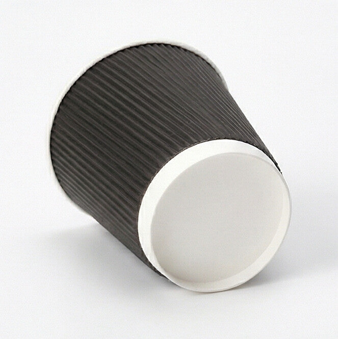 12oz black ripple wall paper cup tipped on its side on light grey, showing the white base ring and base circle