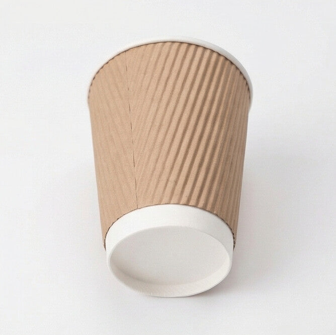 12oz kraft ripple wall paper cup tilted to show the white base band and flat base circle, kraft ripple body on white