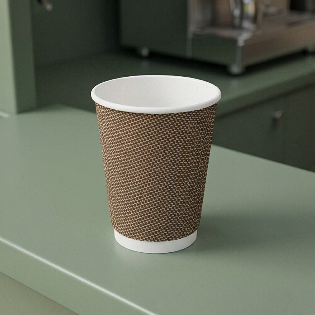 Empty 12oz VIP Ripple Wall Paper Cup on sage green café van counter, espresso machine visible in background