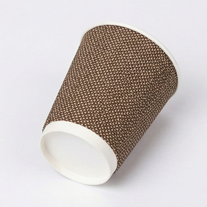 12oz VIP ripple wall paper cup tipped on its side showing base ring and woven exterior, light grey background