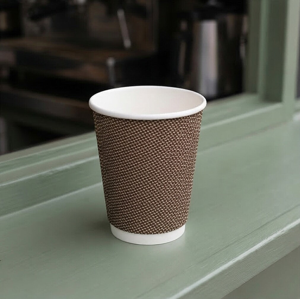12oz VIP Ripple Wall Paper Cup on wooden ledge of sage green coffee van exterior, café equipment behind through window