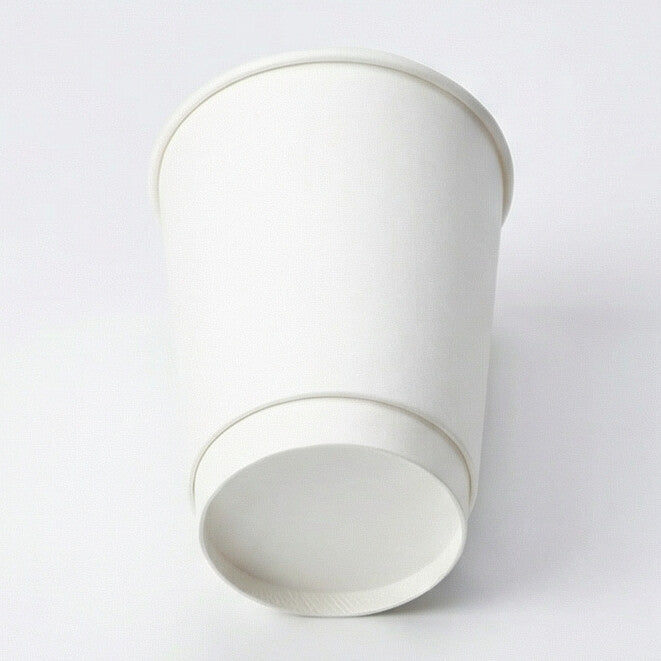 12oz white double wall paper cup tilted right, low angle showing the double-wall base ring and flat base, white background
