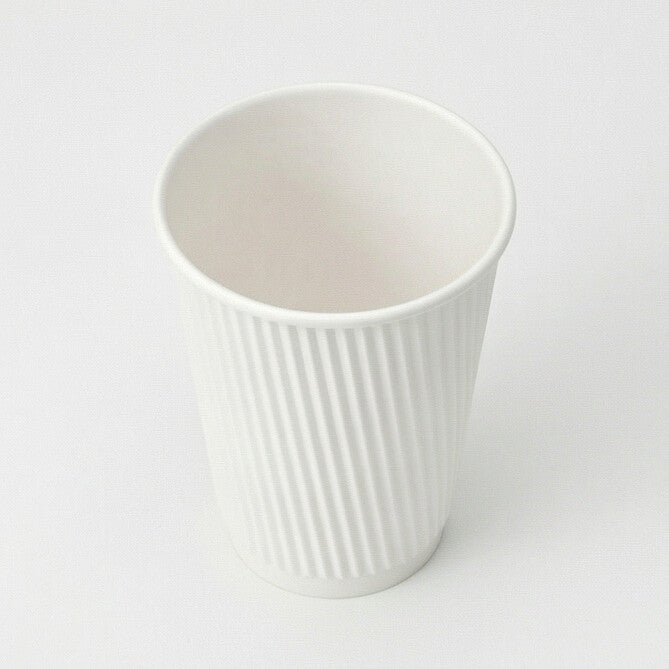 Three-quarter above view of an empty 12oz White Ripple Wall Paper Cup, showing the interior and ripple exterior on grey
