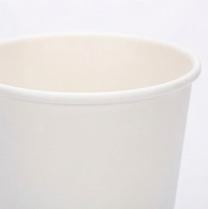 Close-up of the rolled rim and upper interior of a white 12oz paper cup, showing smooth paper finish on a light grey background