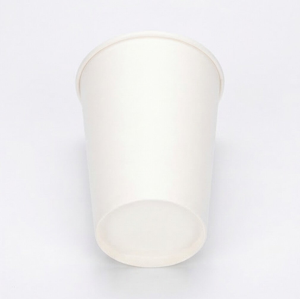 White 12oz paper cup from a slightly elevated angle, base circle visible at the front, interior exposed on grey