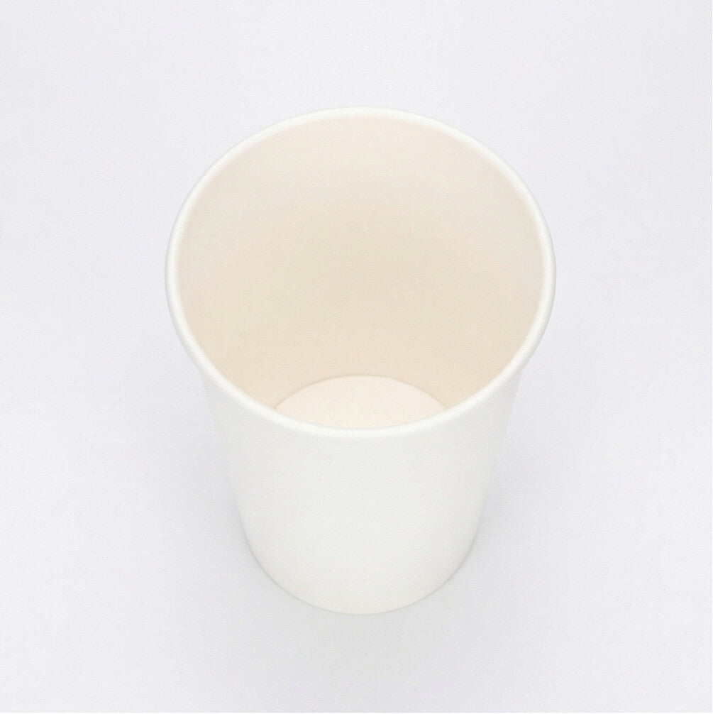Three-quarter elevated studio shot of a white 12oz paper cup on white, angled to reveal the clean interior rim and full body