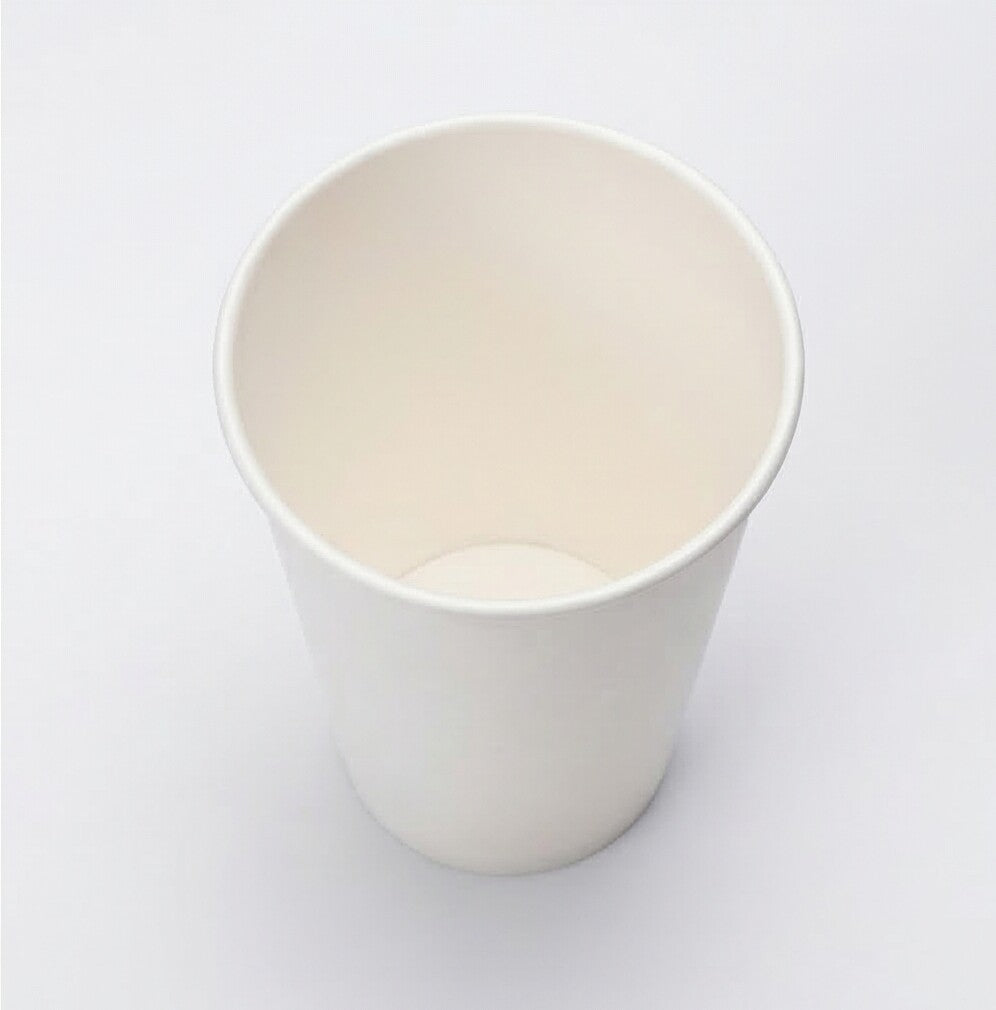 Three-quarter elevated studio shot of a white 16oz paper cup on grey, angled to reveal the full deep interior and tall body