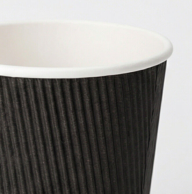 Close-up of the white rim and black vertical ripple texture of a 16oz ripple wall paper cup, light grey background