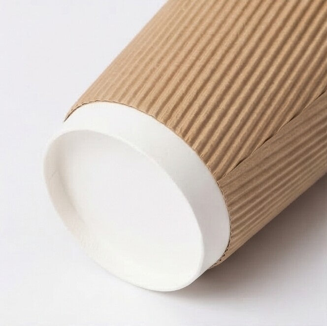 16oz kraft ripple wall paper cup tipped on its side on white, showing the white base ring and base circle close up