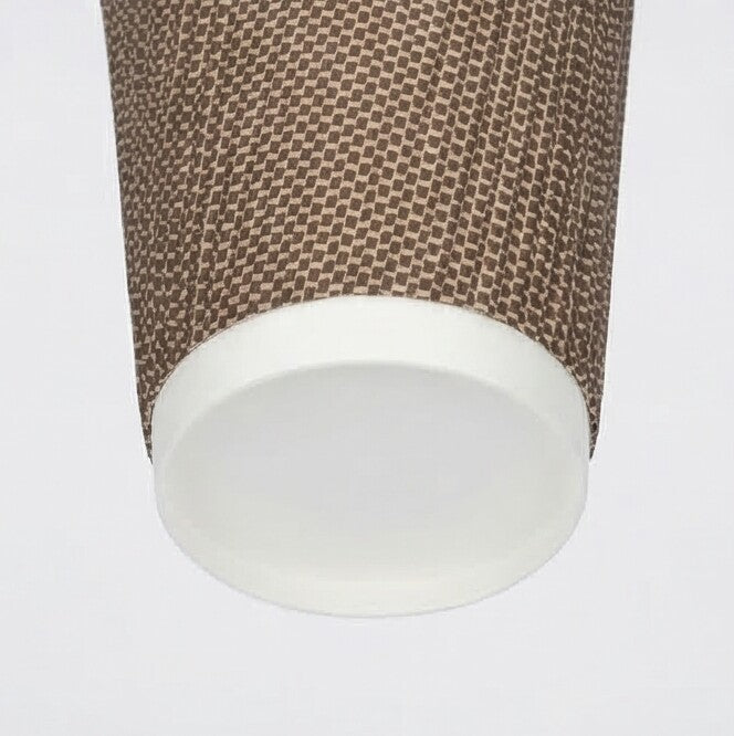 Close-up of the white base ring and lower woven texture of a 16oz VIP Ripple Wall Paper Cup from near-horizontal angle