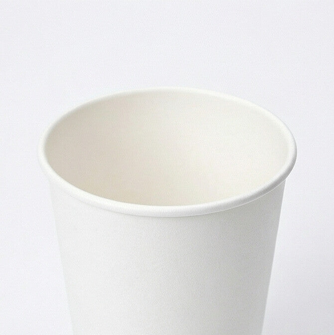 Close-up of the white rolled rim and open interior of a 16oz double wall paper cup from the front, light grey background