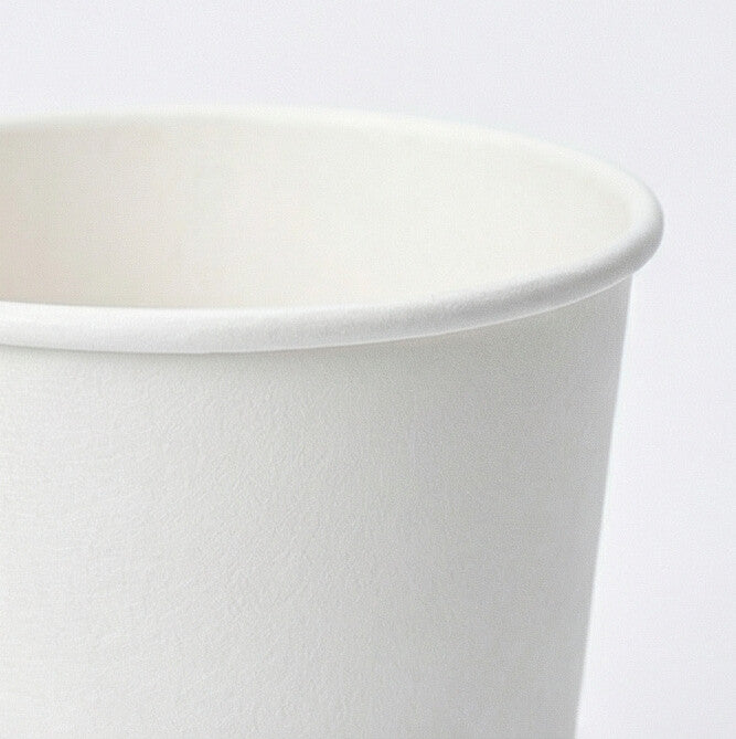 Close-up of the rolled white rim and upper exterior of a 16oz double wall paper cup on a light grey background