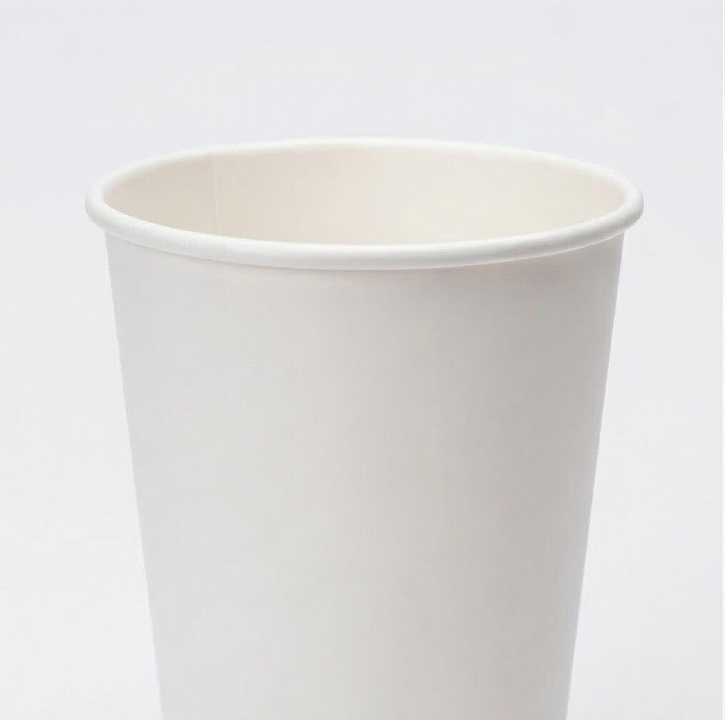 Close-up of the rolled rim and interior opening of a white 16oz paper cup from a slightly elevated front angle on grey