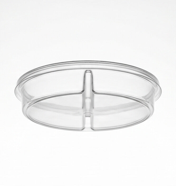 Clear round 2-compartment insert viewed from a low angle, emphasizing the depth of the two compartments and the central divider