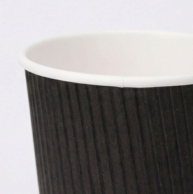 Close-up of the white rim and black vertical ripple texture of an 8oz ripple wall paper cup from the side, grey background