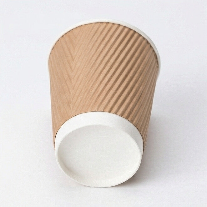 8oz kraft ripple wall paper cup tilted to show the white base band and flat base circle, kraft ripple body on white