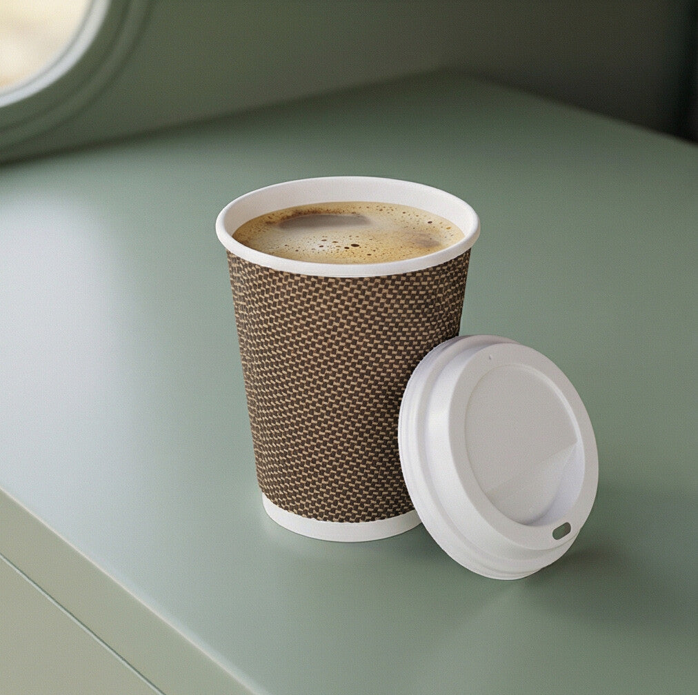 8oz VIP Ripple Wall Paper Cup with frothy coffee on sage green café van counter, white lid resting beside