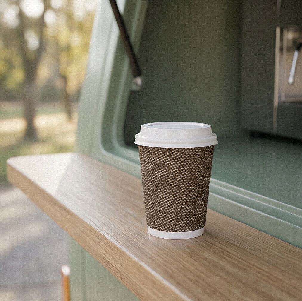 8oz VIP Ripple Wall Paper Cup with white lid on wooden fold-down shelf of sage green coffee van, park behind