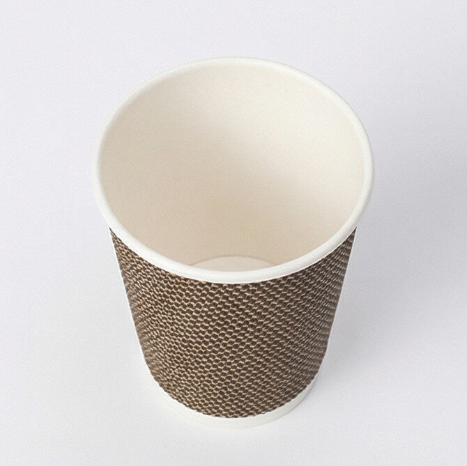 Three-quarter above view of an empty 8oz VIP Ripple Wall Paper Cup showing the interior and woven exterior on grey