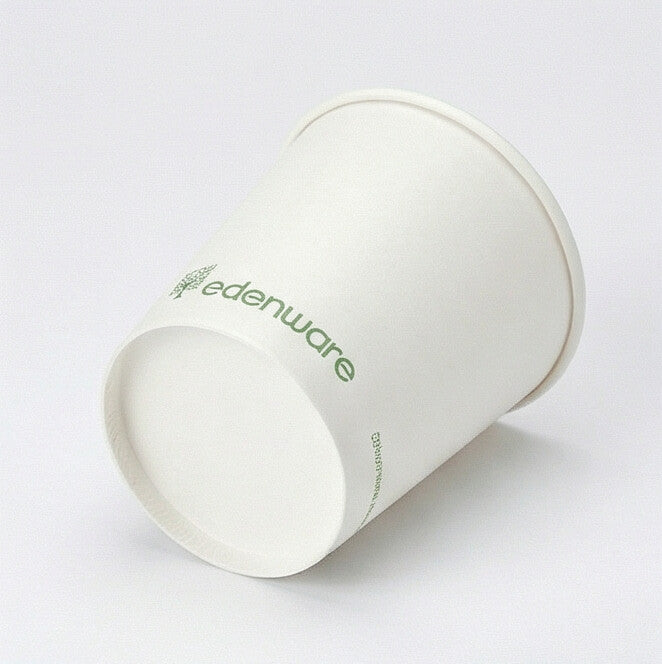 8oz white compostable single wall paper cup lying horizontally showing base and exterior side, light grey background