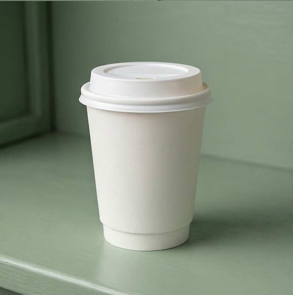 8oz White Double Wall Paper Cup with a white lid on a sage green café shelf, cabinetry and soft shadow behind