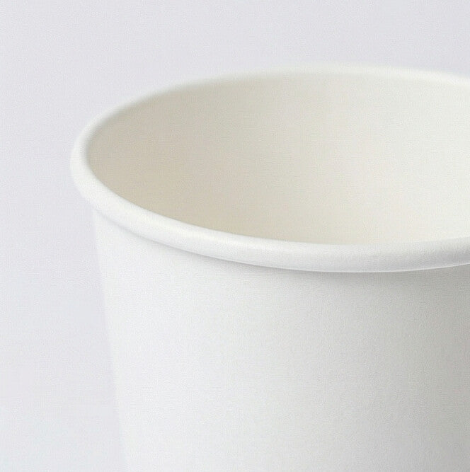 Close-up of the rolled white rim and upper interior of an 8oz double wall paper cup on a light grey background