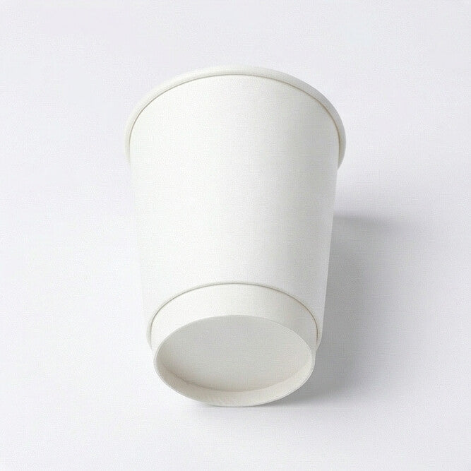 8oz white double wall paper cup tilted to show the double-wall base ring and flat base circle on a white background