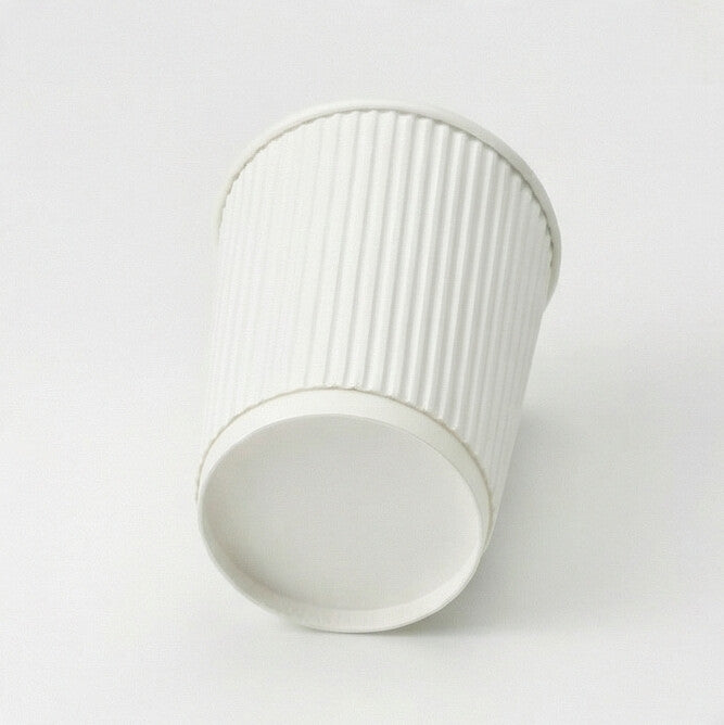 8oz white ripple wall paper cup tilted to show the base ring and base circle, ripple exterior on light grey