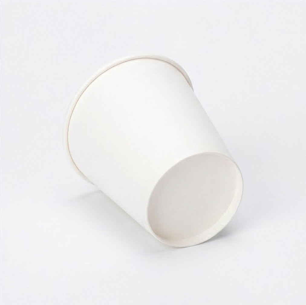 Three-quarter elevated studio shot of a white 8oz paper cup on grey, angled to reveal the full interior rim and body
