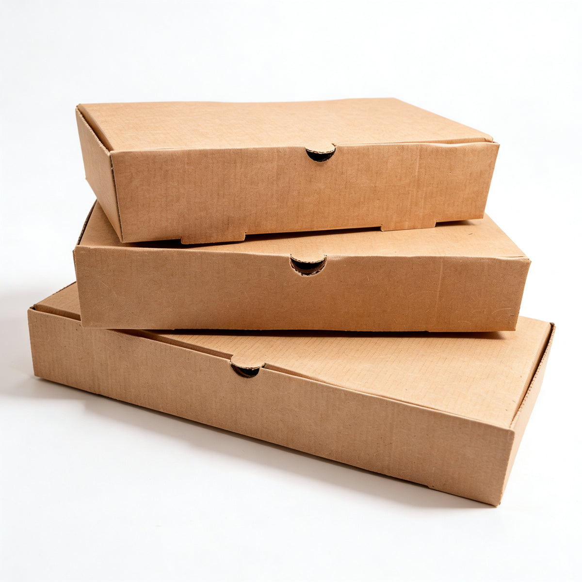 Fish and chips boxes stacked group view showing three closed boxes of varying sizes in natural kraft brown corrugated construction on white background