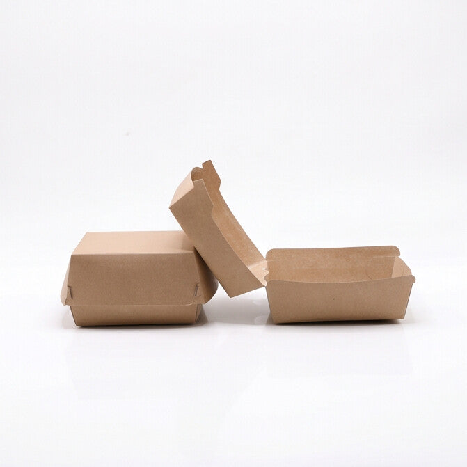 Large kraft burger boxes group view showing three boxes — one closed, one lid leaning open, and one open base — natural kraft paper construction on white background