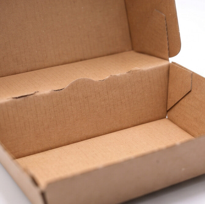 Medium corrugated burger box open, close-up interior angle view showing corrugated kraft construction detail, scalloped front panel and interior base