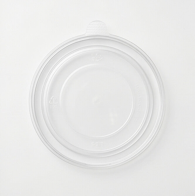 Clear 150mm PET lid viewed from directly above, showing the recessed flat center, concentric rings, PET recycling marks and side pull tab on a white background
