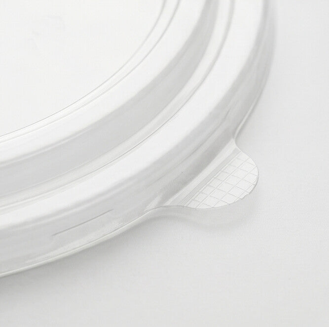 Close-up detail of the textured grid pull tab and stepped rim rings of a clear 183mm PET lid.