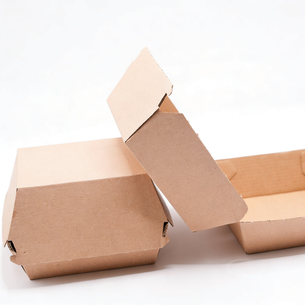 Small corrugated burger boxes styled group view showing one closed box, one open with lid raised, and one flat base, natural kraft brown corrugated construction on white background
