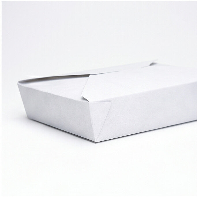 Close-up detail of white paper takeaway food container No. 2 closed, showing fold-over flap, tuck-in tab and corner construction