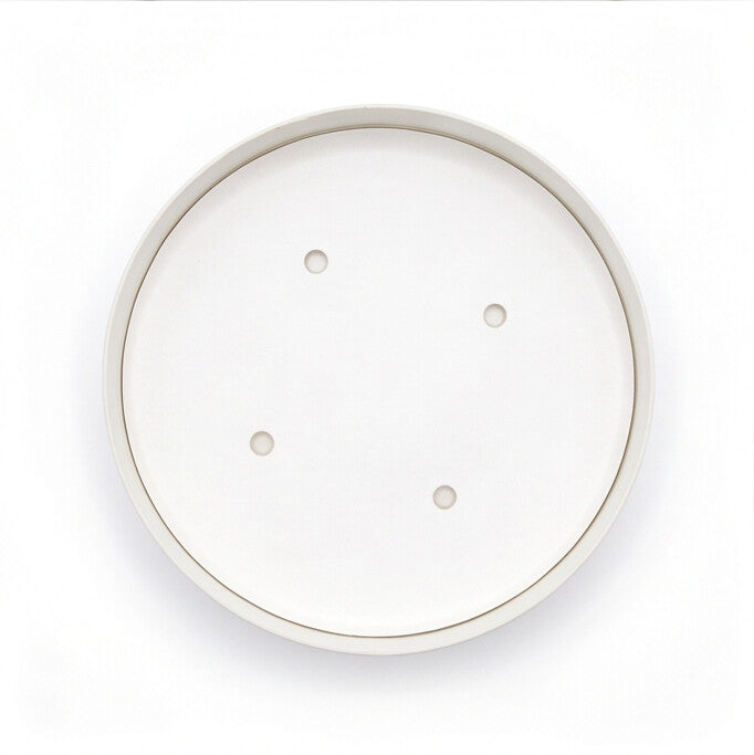 Top-down view of white paper vented lid 98mm showing four ventilation holes on clean white surface