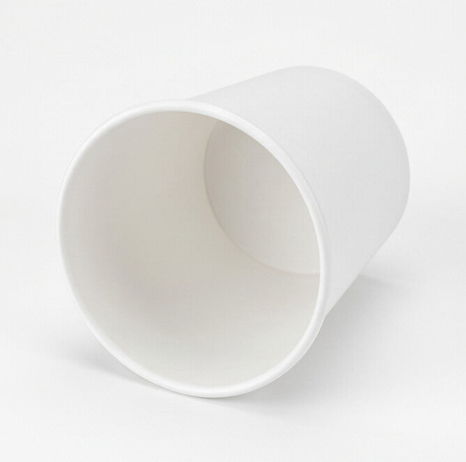 White paper soup container 32oz tilted to show the open mouth, interior and base.
